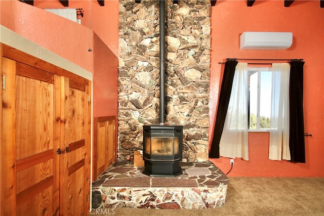 details with a wall mounted AC, carpet floors, and a wood stove