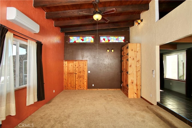 empty room featuring carpet flooring, beam ceiling, a wall mounted air conditioner, and ceiling fan