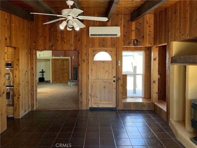 carpeted foyer featuring wooden ceiling, ceiling fan, a towering ceiling, beamed ceiling, and a wall unit AC