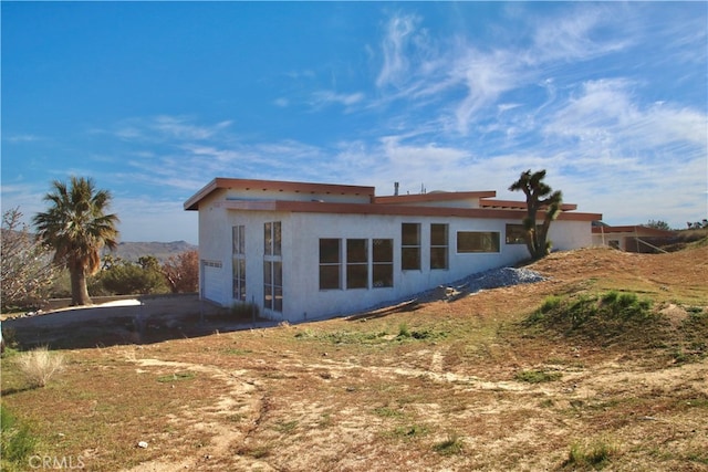 rear view of house with a garage