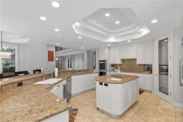 kitchen with a notable chandelier, white cabinetry, light tile floors, and light stone counters