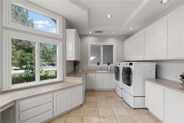 laundry room featuring sink, cabinets, washer and dryer, and light tile floors