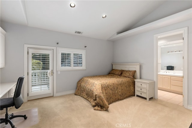 bedroom with light carpet, ensuite bath, access to exterior, lofted ceiling, and sink