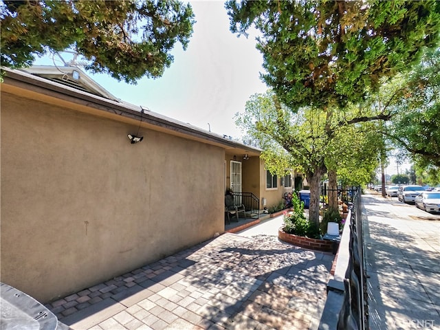 view of side of home featuring a patio area