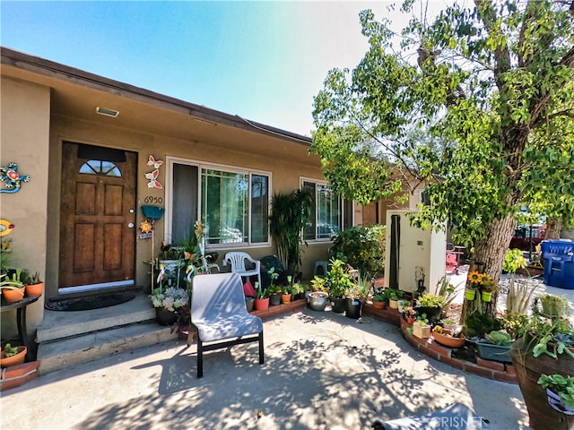 entrance to property featuring a patio area