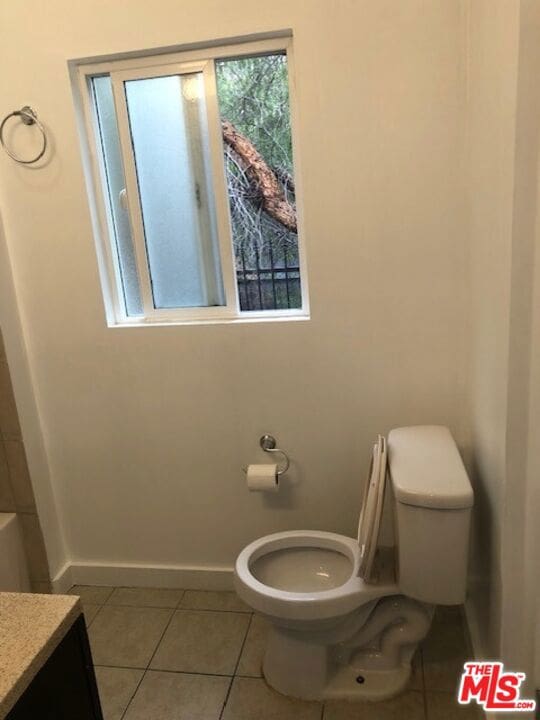 bathroom featuring vanity, toilet, and tile patterned floors