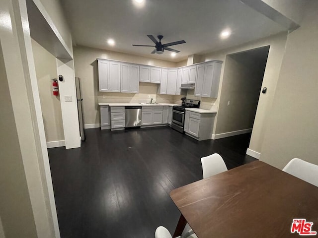 kitchen with ceiling fan, sink, dark wood-type flooring, white cabinetry, and appliances with stainless steel finishes