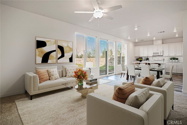 carpeted living room featuring ceiling fan