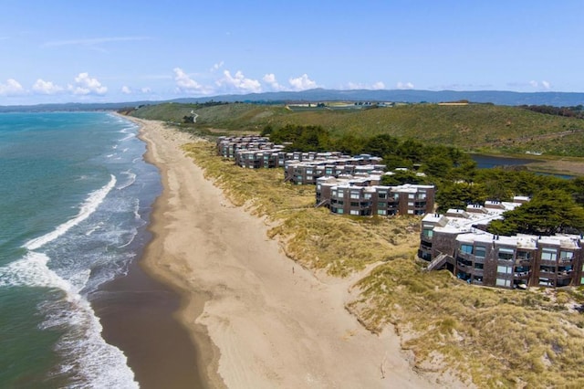 birds eye view of property with a beach view and a water view