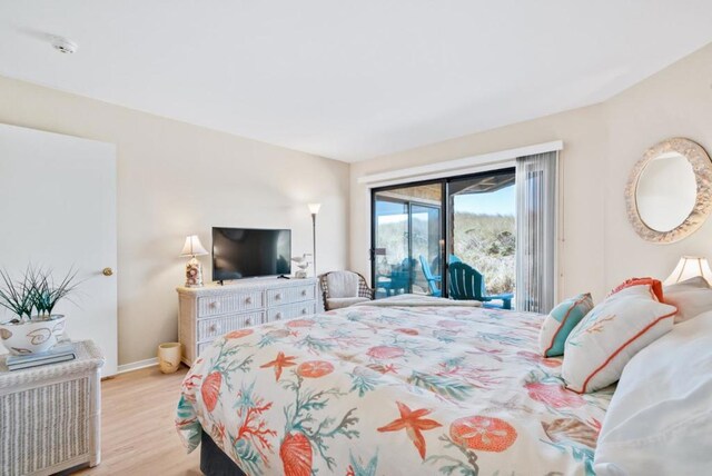 bedroom featuring light wood-type flooring and access to exterior