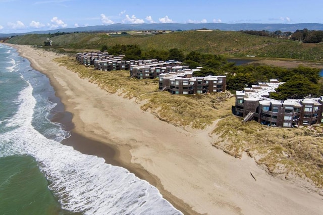 birds eye view of property with a view of the beach and a water view