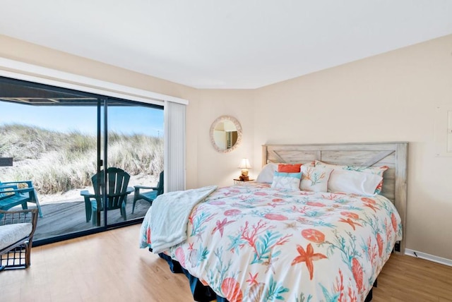 bedroom featuring access to exterior and wood-type flooring