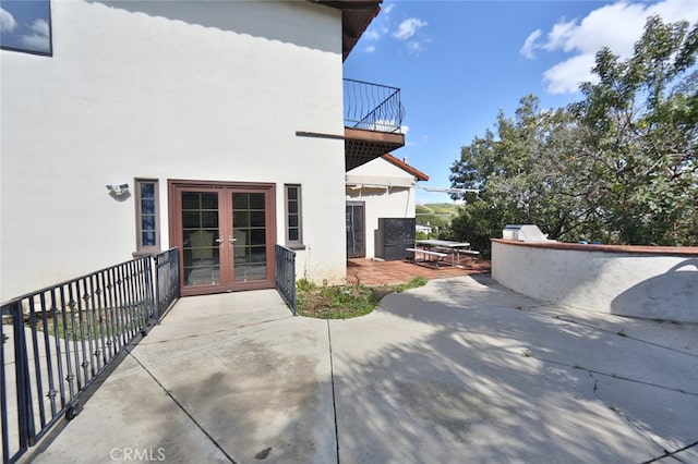 view of patio / terrace with a balcony and french doors