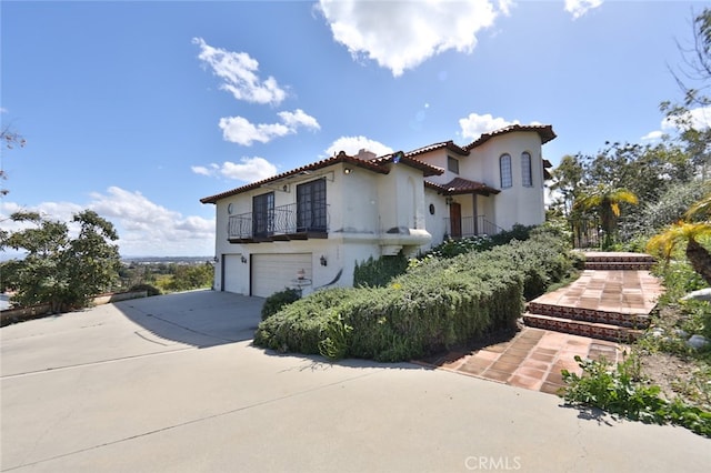 mediterranean / spanish-style house with a garage