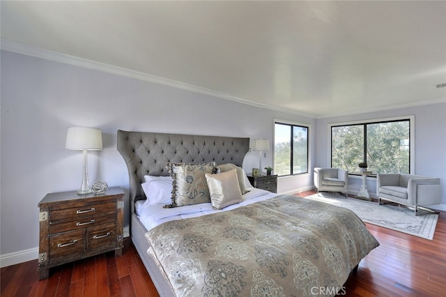 bedroom with dark hardwood / wood-style flooring and crown molding