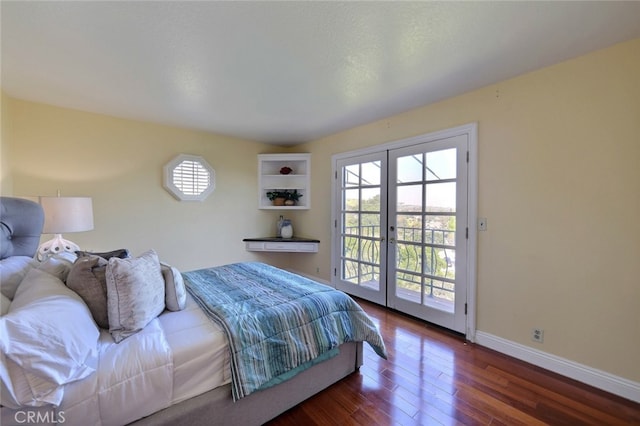 bedroom featuring access to exterior, dark hardwood / wood-style floors, and french doors