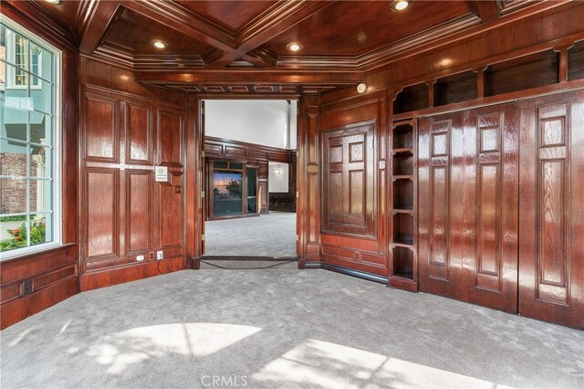 entryway featuring wooden walls, plenty of natural light, and carpet