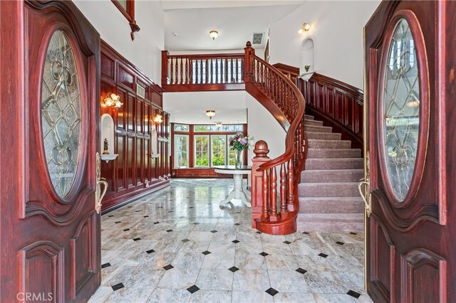 entryway with french doors and a towering ceiling