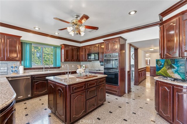 kitchen with crown molding, sink, an island with sink, and black appliances