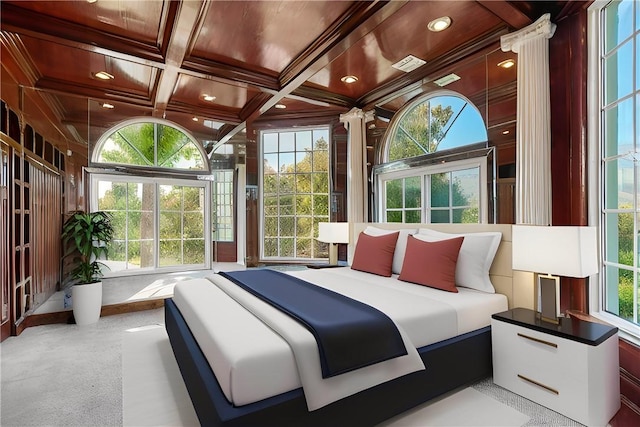 bedroom featuring beamed ceiling, multiple windows, and coffered ceiling