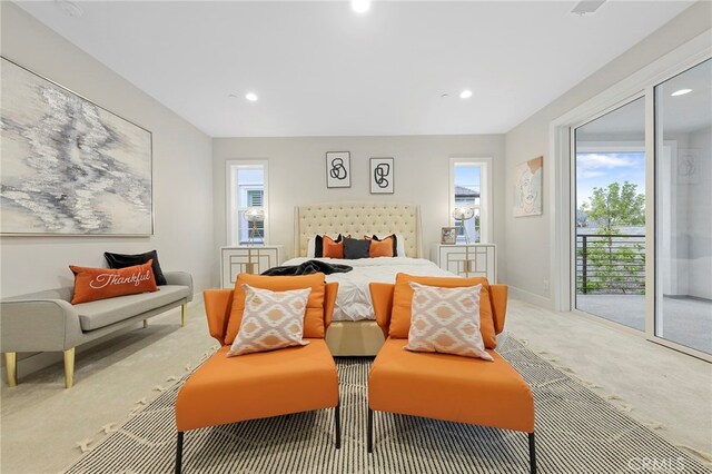 bedroom with access to outside and light colored carpet