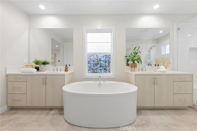 bathroom with dual bowl vanity and tile flooring