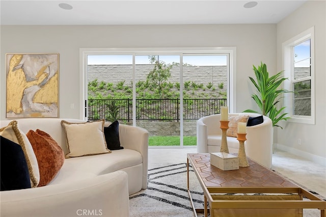 living room with light colored carpet and plenty of natural light