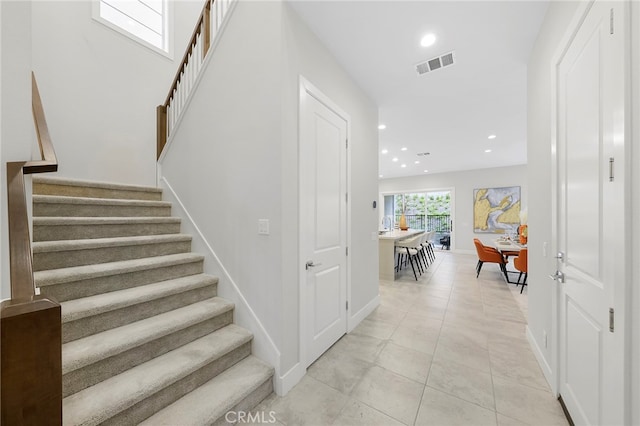 stairs with light tile flooring