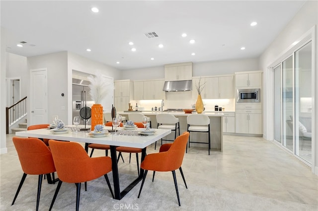 tiled dining room with sink