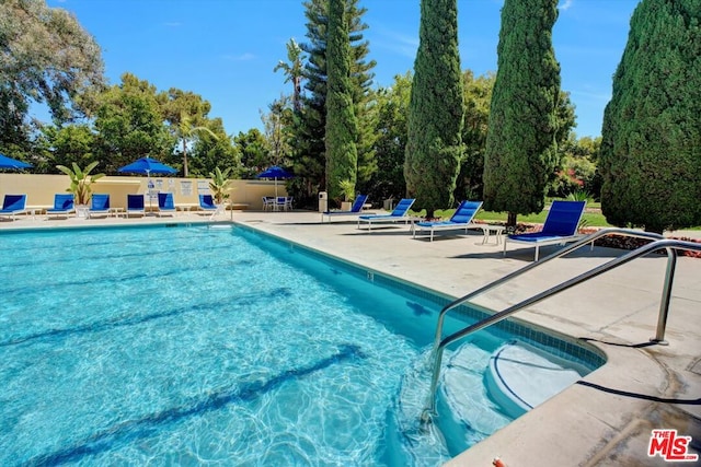 view of swimming pool with a patio area