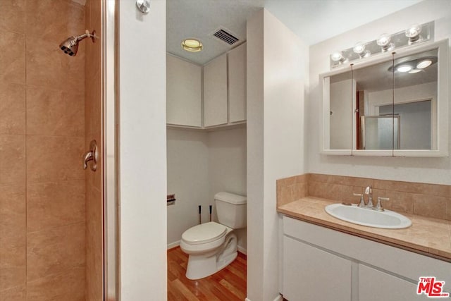 bathroom featuring toilet, hardwood / wood-style floors, and vanity