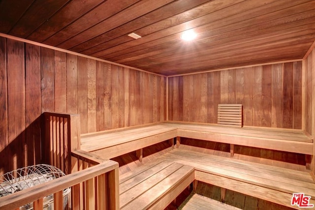 view of sauna with wooden walls and wooden ceiling