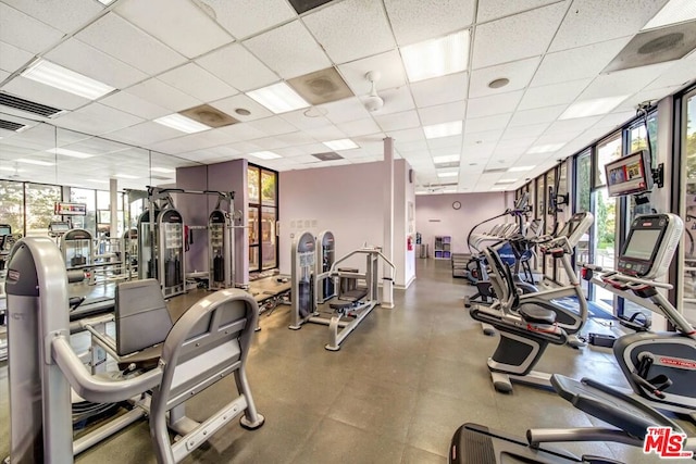 workout area with a paneled ceiling