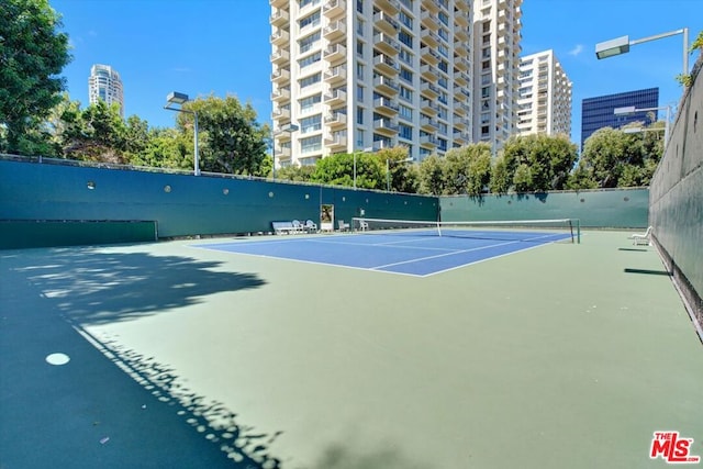 view of sport court with basketball hoop