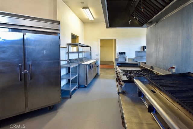 kitchen featuring concrete flooring and a high ceiling