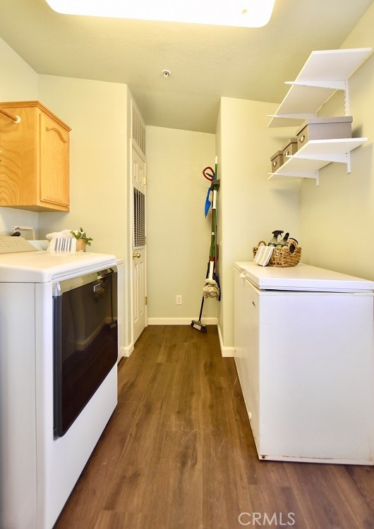 laundry room with cabinets and dark wood-type flooring