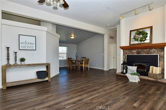 living room with dark hardwood / wood-style floors, ceiling fan, and track lighting