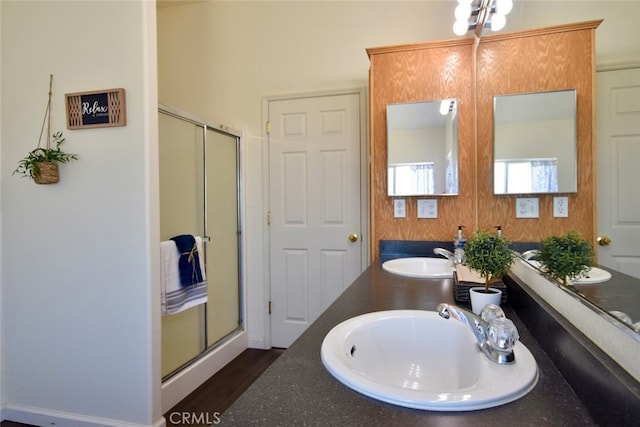 bathroom featuring walk in shower, hardwood / wood-style flooring, and dual vanity