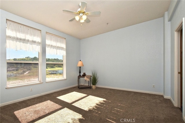 carpeted empty room featuring ceiling fan