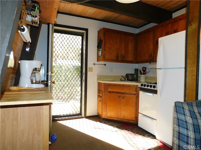 kitchen featuring white appliances, dark carpet, wood ceiling, and sink