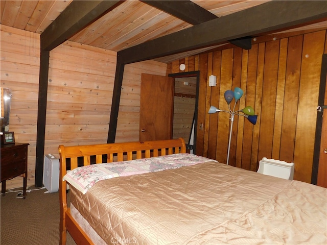 bedroom featuring beam ceiling and wooden walls