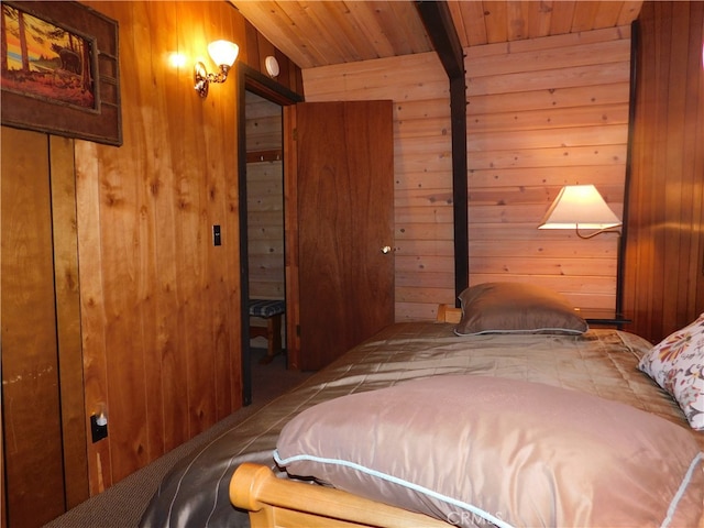 bedroom featuring wooden ceiling and wood walls