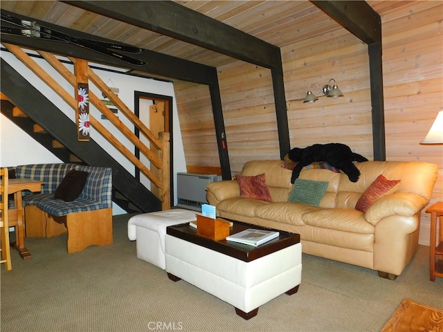 carpeted living room with wooden walls and beamed ceiling