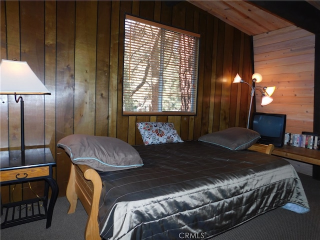 carpeted bedroom with wooden walls