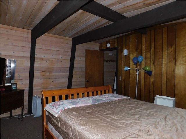 bedroom with wood walls and beamed ceiling