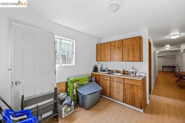 kitchen with light hardwood / wood-style floors and sink