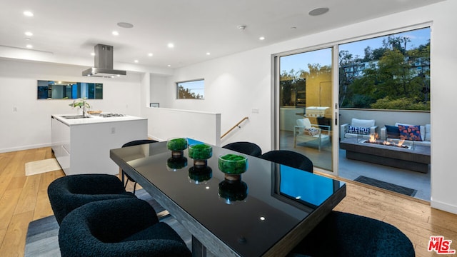 dining space featuring sink and light hardwood / wood-style flooring