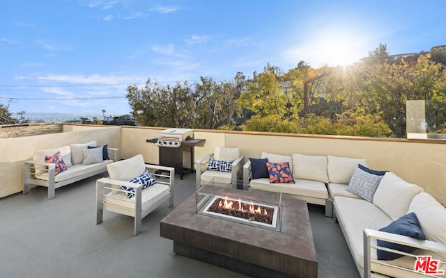 view of patio / terrace featuring a grill and an outdoor living space with a fire pit