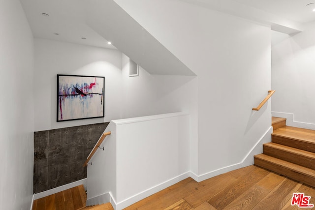 stairs with hardwood / wood-style flooring