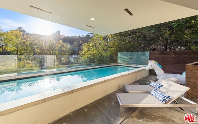 view of swimming pool featuring a mountain view